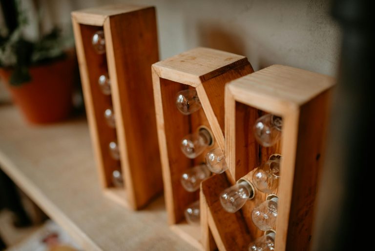 A close-up of vintage wooden frame filled with light bulbs on a shelf, offering a rustic decor touch.