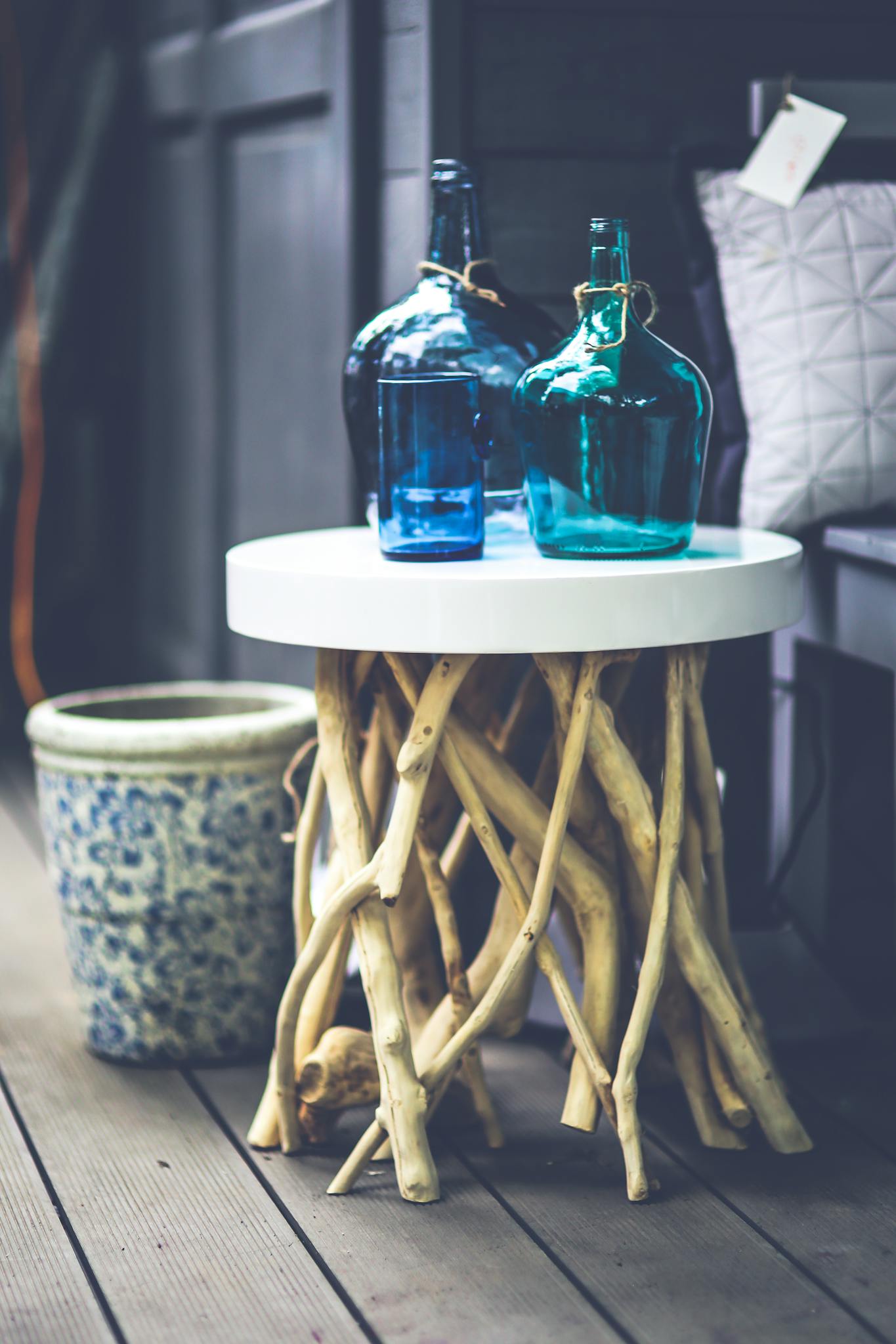 A rustic wooden table with blue glass bottles, perfect for modern interior decoration.