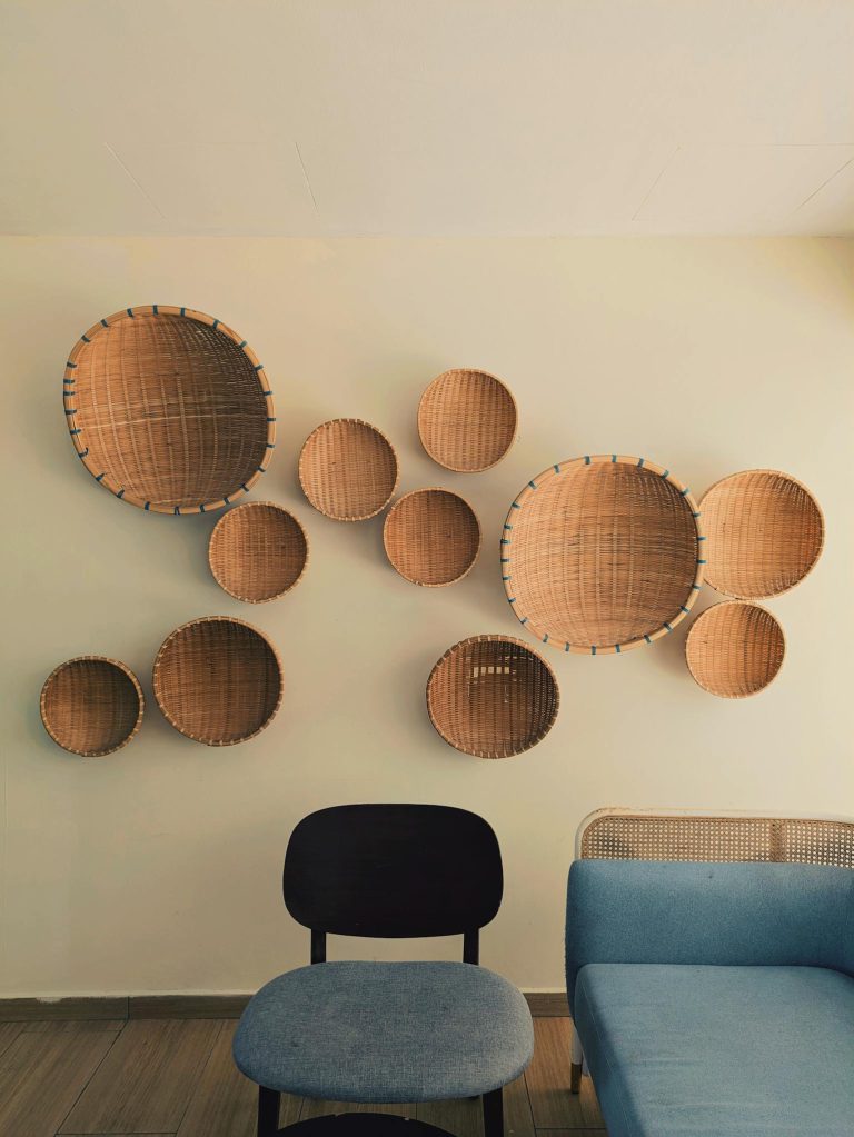 Stylish modern interior with woven wall baskets and contemporary chairs.